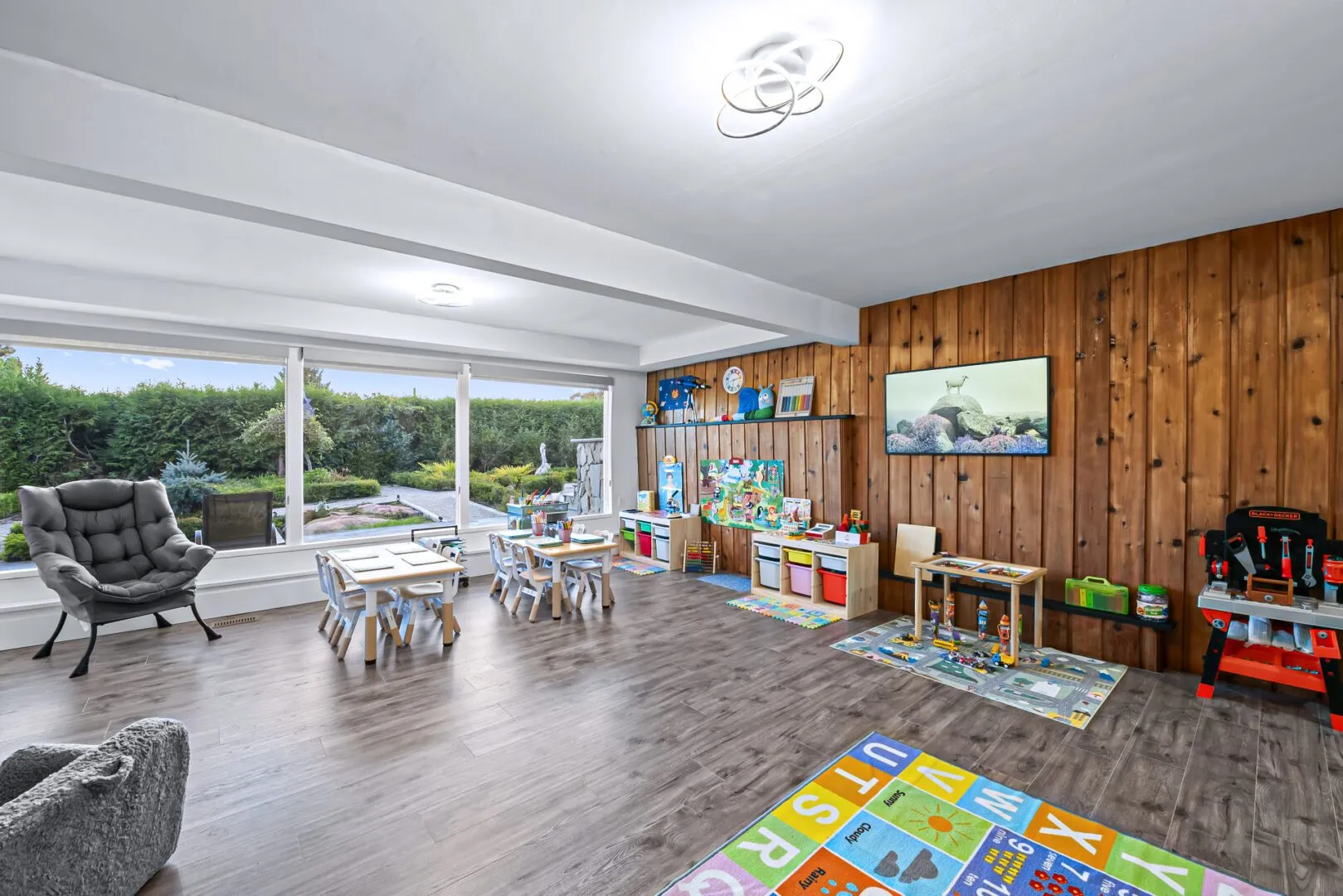 Light-filled classroom with garden views, reading chairs and learning centres